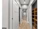 Hallway with white doors, modern lighting, wood-look flooring, and an open storage area at 10 Last St, Moreland, GA 30259