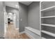 Hallway with storage and bench leading into the kitchen with modern appliances at 10 Last St, Moreland, GA 30259