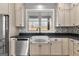 Close-up of the farmhouse sink and stainless steel dishwasher at 10 Last St, Moreland, GA 30259