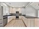 Kitchen features stainless appliances, cream cabinets and a black countertop at 10 Last St, Moreland, GA 30259