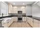 Kitchen featuring stainless appliances, cream cabinets and black countertops at 10 Last St, Moreland, GA 30259