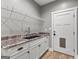 Laundry room with granite countertop, modern faucet, and convenient access door at 10 Last St, Moreland, GA 30259