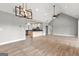 Spacious living room with vaulted ceilings adjacent to open kitchen area at 10 Last St, Moreland, GA 30259