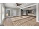 Open living room with hardwood floors, recessed lighting, and view of the kitchen at 10 Last St, Moreland, GA 30259