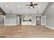 Spacious living room with luxury vinyl plank flooring and vaulted ceiling opens to kitchen at 10 Last St, Moreland, GA 30259