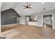 Spacious living room with luxury vinyl plank flooring and vaulted ceiling opens to kitchen at 10 Last St, Moreland, GA 30259