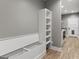 Mudroom with open storage bench, cubbies, white trim, and convenient outlets at 10 Last St, Moreland, GA 30259
