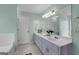 Bright bathroom featuring a tub, shower, and dual sink vanity at 160 Vinnys Way, Covington, GA 30014