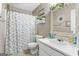 Neutral bathroom featuring a shower/tub combo, framed mirror, and white single sink vanity at 1012 Matthews Way, Mcdonough, GA 30252