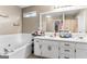 Neutral bathroom with dual sinks, large vanity, and a seperate soaking tub at 1012 Matthews Way, Mcdonough, GA 30252