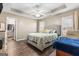 A spacious bedroom with a tray ceiling and a large upholstered bed frame at 1012 Matthews Way, Mcdonough, GA 30252