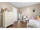 Bright bedroom features a white dresser, decorative mirror and a white metal bed frame at 1012 Matthews Way, Mcdonough, GA 30252
