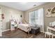 Comfortable bedroom with wood floors, a window and bright natural light creating a serene and inviting atmosphere at 1012 Matthews Way, Mcdonough, GA 30252