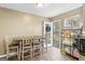 Cozy dining nook features a dining table, tiled floors, and a bright view of the outdoors through the screened door at 1012 Matthews Way, Mcdonough, GA 30252