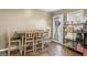 Cozy dining nook features a dining table, tiled floors, and a bright view of the outdoors through the screened door at 1012 Matthews Way, Mcdonough, GA 30252