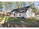 Exterior view of a home featuring a covered patio and mature trees, providing a private outdoor space at 1012 Matthews Way, Mcdonough, GA 30252