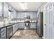 Modern kitchen with stainless steel appliances, granite countertops, and ample cabinet space for storage and meal prep at 1012 Matthews Way, Mcdonough, GA 30252