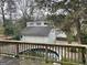 Backyard featuring an above ground pool, a deck with wood railings, and a detached garage at 1867 Dresden Dr, Atlanta, GA 30319