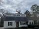 Charming single-Gathering home with a unique design, black shutters, and a well-kept front yard at 1867 Dresden Dr, Atlanta, GA 30319