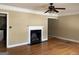 Bright living room featuring a classic fireplace, hardwood floors, crown molding, and a ceiling fan at 1867 Dresden Dr, Atlanta, GA 30319
