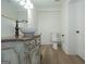 Updated bathroom featuring a decorative mirror, custom vanity and hardwood floors; toilet in the background at 1269 Snapping Shoals Rd, Mcdonough, GA 30252