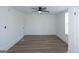 Well-lit empty bedroom with modern ceiling fan and hardwood flooring, plus a large window offering ample light at 1269 Snapping Shoals Rd, Mcdonough, GA 30252