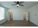 Empty bedroom featuring hardwood floors, closet access and a modern ceiling fan, plus a window offering light at 1269 Snapping Shoals Rd, Mcdonough, GA 30252