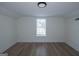 Bright, empty bedroom featuring hardwood floors and a window that allows plenty of natural light to fill the room at 1269 Snapping Shoals Rd, Mcdonough, GA 30252