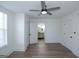Spacious bedroom with a view to the ensuite bathroom; includes a modern ceiling fan and beautiful floors at 1269 Snapping Shoals Rd, Mcdonough, GA 30252