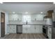 Kitchen with farmhouse sink, stainless steel appliances, shaker cabinets, and hardwood floors at 1269 Snapping Shoals Rd, Mcdonough, GA 30252
