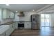 Open-concept kitchen with hardwood floors features stainless steel appliances and access to the deck at 1269 Snapping Shoals Rd, Mcdonough, GA 30252