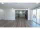 Open-concept living room showcasing the modern kitchen and sliding door access to the deck at 1269 Snapping Shoals Rd, Mcdonough, GA 30252
