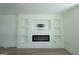 Bright living room showcasing a sleek electric fireplace and custom built-ins at 1269 Snapping Shoals Rd, Mcdonough, GA 30252