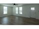 Living room featuring three bright windows, enhancing the space with natural light at 1269 Snapping Shoals Rd, Mcdonough, GA 30252