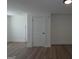 Bright room featuring hardwood floors, neutral walls, and classic white door at 1269 Snapping Shoals Rd, Mcdonough, GA 30252