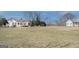 Sprawling yard with multiple houses under a blue sky and bare trees at 1269 Snapping Shoals Rd, Mcdonough, GA 30252