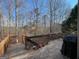 Wood deck overlooking a wooded area with potted plants and outdoor seating, perfect for relaxation at 306 Oakwind Way, Canton, GA 30114