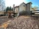 Rear exterior view showcases the deck, patio, and wooded backyard that enhances the home's charm at 306 Oakwind Way, Canton, GA 30114