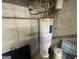 Basement water heater with associated pipes and fittings, set against a concrete foundation wall at 306 Oakwind Way, Canton, GA 30114