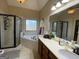 Elegant bathroom boasting a separate shower, luxurious soaking tub and large window with natural light at 306 Oakwind Way, Canton, GA 30114