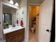 Bathroom featuring a modern sink vanity, decorative mirror, and separate toilet room, enhancing privacy at 306 Oakwind Way, Canton, GA 30114