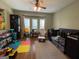 Cozy bedroom featuring a ceiling fan, hardwood floors, and large windows providing ample natural light at 306 Oakwind Way, Canton, GA 30114