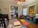 Bright bedroom with a view into the main bedroom through an archway and colorful decorations and toys at 306 Oakwind Way, Canton, GA 30114