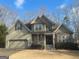 Charming two-story home with attached two-car garage and covered porch entrance at 306 Oakwind Way, Canton, GA 30114
