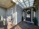Charming front porch with seating area, decorative wreath, and a welcoming entrance at 306 Oakwind Way, Canton, GA 30114