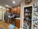 A kitchen with stainless steel appliances, wooden cabinets, pantry and hardwood floors at 306 Oakwind Way, Canton, GA 30114