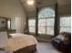 Main bedroom with high ceilings, and large windows providing natural light at 306 Oakwind Way, Canton, GA 30114
