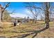 Lush backyard with a shed, swingset, and trampoline, offering a large outdoor space for recreational activities at 5700 Mount Zion Rd, Waco, GA 30182