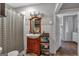 Neutral bathroom features a sink, vanity, a shower with striped curtain, and natural light at 5700 Mount Zion Rd, Waco, GA 30182