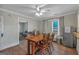 Bright dining room features hardwood floors, modern ceiling fan, and stainless steel refrigerator at 5700 Mount Zion Rd, Waco, GA 30182